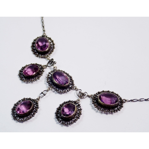 392 - An early 20th century white metal necklace set six oval cut amethysts, clasp a/f