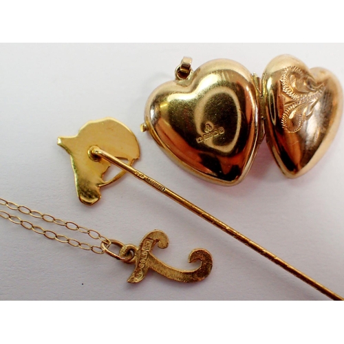 394 - A 9 carat gold heart form locket, a 9 carat gold horse head stick pin, 2.4g, three Egyptian yellow m... 