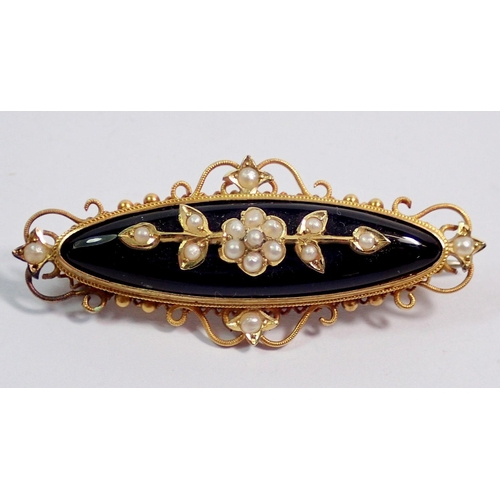 396 - A gold mourning brooch set pearls on black onyx 4.5cm wide