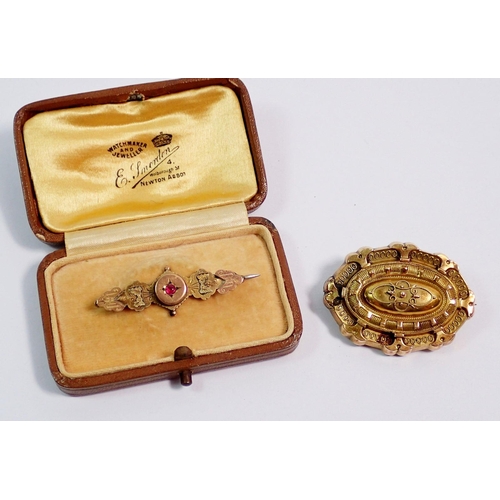 397 - Two Victorian gold brooches, one boxed and set with a ruby, 4cm wide