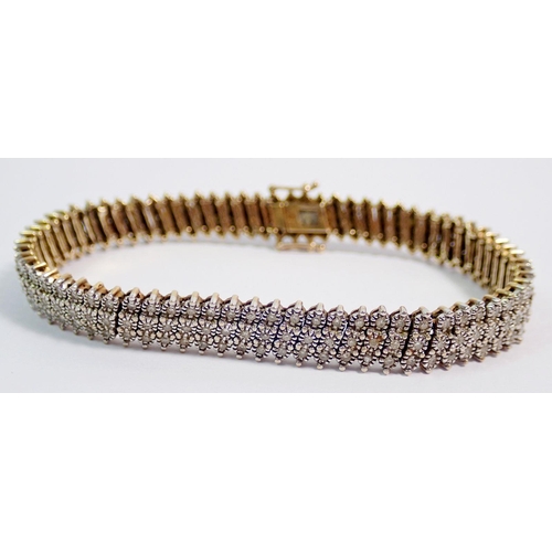 407 - A 9 carat white and yellow gold bracelet set triple row of diagonal diamonds, 18.6g, 18.5cm long