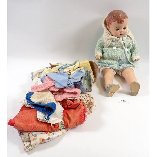 533 - A French 1940's composition doll, 38cm with a selection of outfits