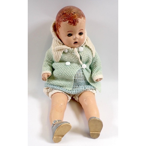 533 - A French 1940's composition doll, 38cm with a selection of outfits