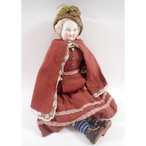 535 - A 19th century bisque shoulderhead doll wtih painted face, soft body, porcelain arms and leather boo... 