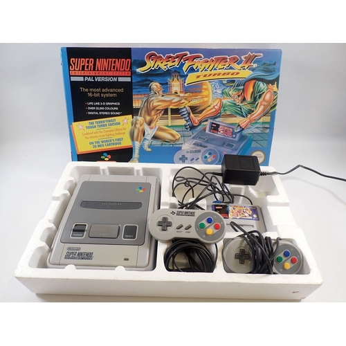 544 - A Super Nintendo Entertainment system (SNES) console containing Street Fighter II Turbo complete wit... 