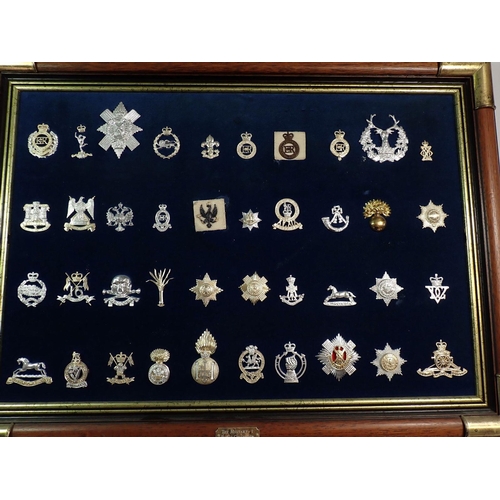 699 - Two framed displays of eighty Stay Bright military cap badges (please note - some badges may be re-s... 