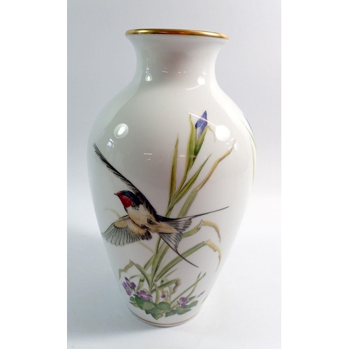 71 - A Franklin Mint porcelain vase decorated birds and flowers, 30cm