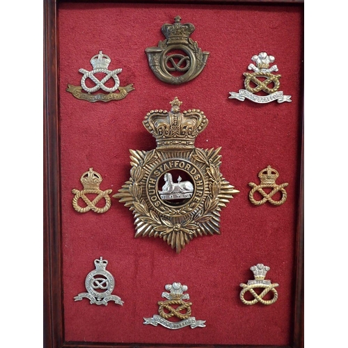 713 - A framed display of sixteen Royal Engineers military cap badges, a framed display of seventeen Welsh... 