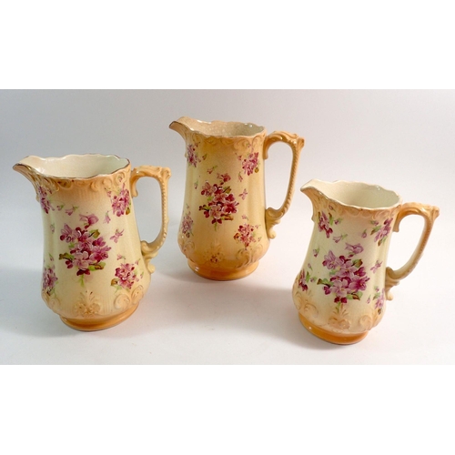 73 - A set of three B & K Edwardian floral printed graduated jugs, tallest 21cm tall