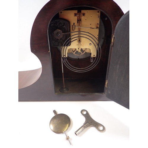 732 - A 1920's mahogany eight day striking mantel clock with presentation plaque, key and pendulum, 45cm w... 