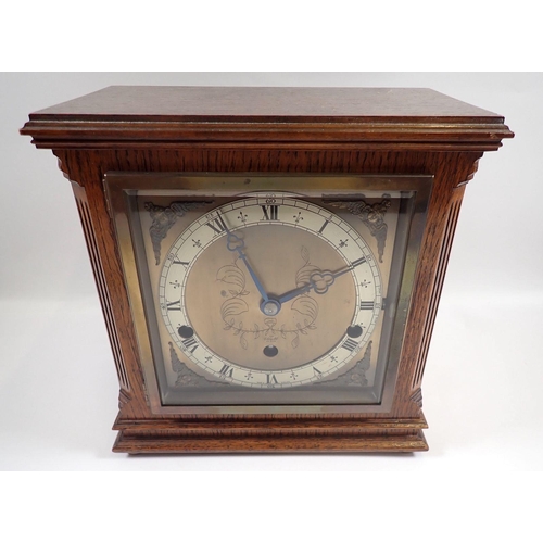 733 - An Elliot oak striking mantel clock, 23cm tall