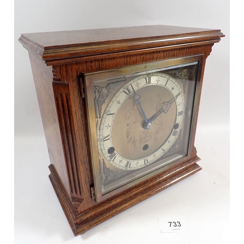 733 - An Elliot oak striking mantel clock, 23cm tall