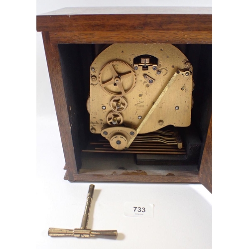 733 - An Elliot oak striking mantel clock, 23cm tall