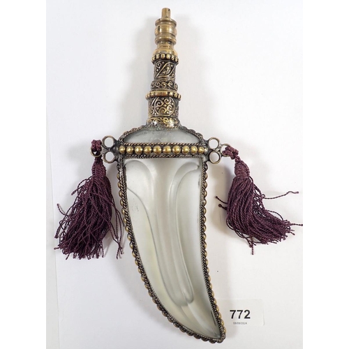 772 - A Middle Eastern glass scent bottle in the form of a dagger with gilt metal mounts, 7.5cm tall