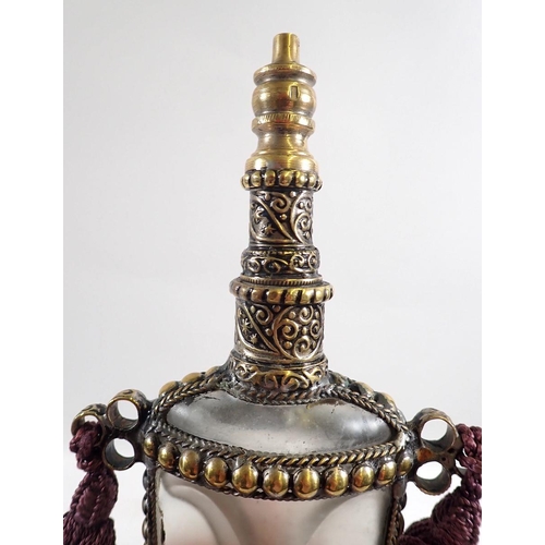 772 - A Middle Eastern glass scent bottle in the form of a dagger with gilt metal mounts, 7.5cm tall