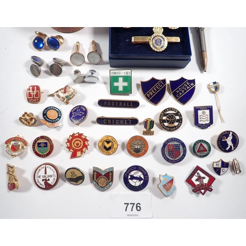 776 - A box of badges including Manchester United, school prefect etc plus some cufflinks