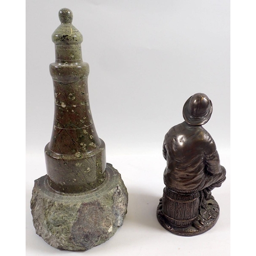 803 - A carved stone lighthouse, 23cm and a bronze finish fisherman