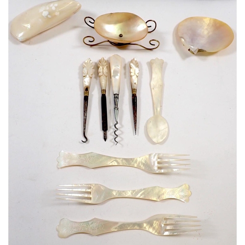 812 - A collection of mother of pearl items including cutlery, pin dishes and a manicure set