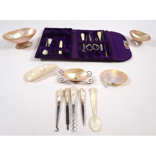 812 - A collection of mother of pearl items including cutlery, pin dishes and a manicure set