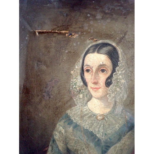 861 - A Victorian oil on canvas portrait of a woman in a blue dress, distressed, 42 x 38cm