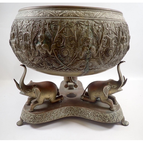 872 - A late 19th century Indian brass bowl on triform stand with three elephant supports, 30cm tall