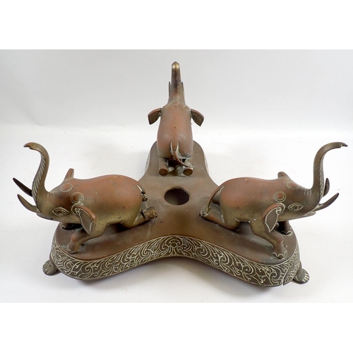 872 - A late 19th century Indian brass bowl on triform stand with three elephant supports, 30cm tall