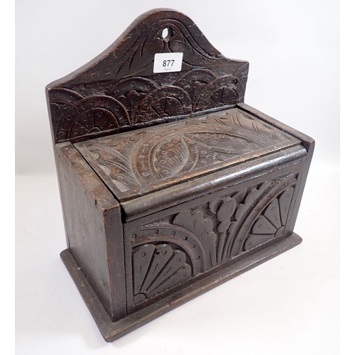 877 - An antique oak candle box with lunette carving, 30cm wide x 29cm tall