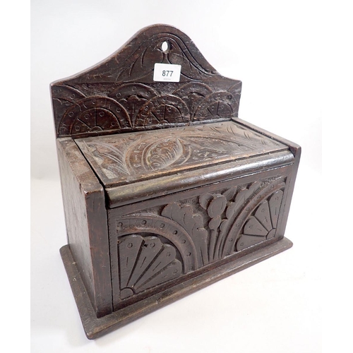 877 - An antique oak candle box with lunette carving, 30cm wide x 29cm tall