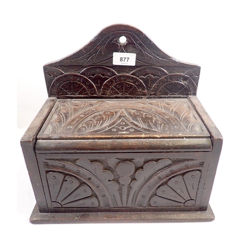 877 - An antique oak candle box with lunette carving, 30cm wide x 29cm tall