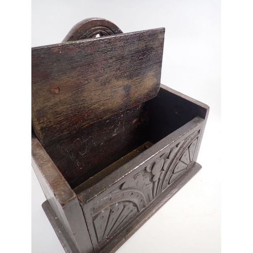 877 - An antique oak candle box with lunette carving, 30cm wide x 29cm tall