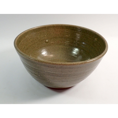 88 - A green glazed studio pottery bowl, 25cm diameter