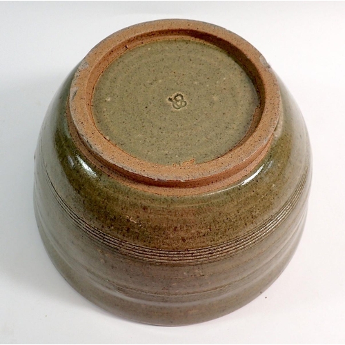 88 - A green glazed studio pottery bowl, 25cm diameter