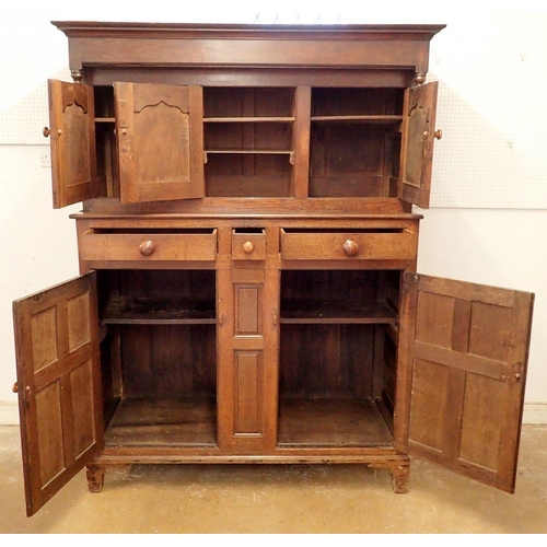 885 - A 19th century Welsh oak Deuddarn with three arch panel doors over three drawers and two panelled cu... 