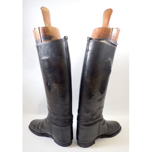 887 - A pair of antique black leather riding boots and wooden trees