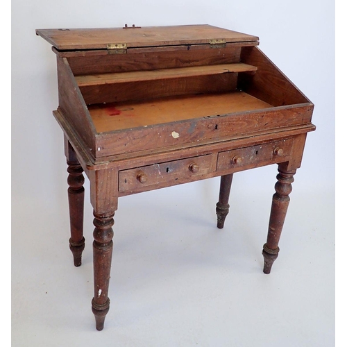 891 - A Victorian elm teachers desk with slope top over two drawers all raised on slender turned supports,... 