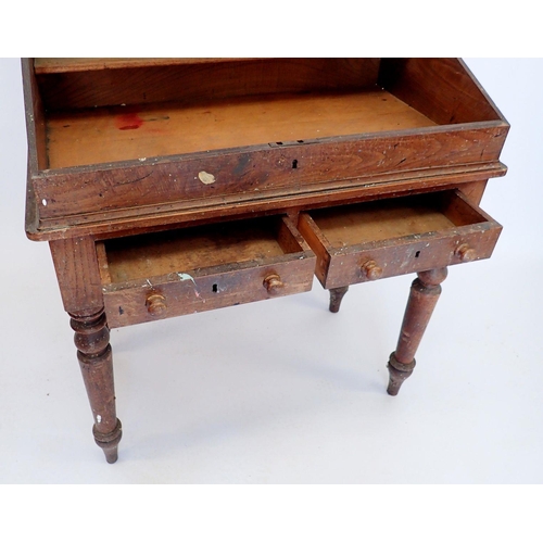 891 - A Victorian elm teachers desk with slope top over two drawers all raised on slender turned supports,... 