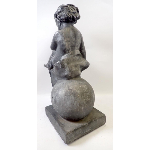 903 - An antique lead garden figure of a cherub seated on sphere, on plinth base, 39cm high