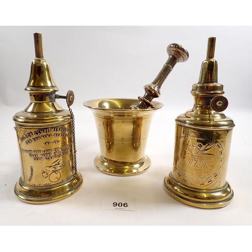 906 - A brass pestle and mortar and two pigeon lamps