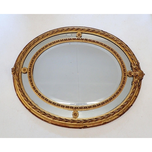 919 - A 19th century gilt oval laurel moulded mirror with foliate applied surmount, 88 x 72cm