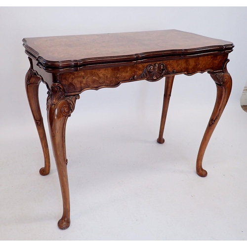 926 - A 20th century walnut fold top card table with scroll craved apron and shell and scroll carved cabri... 