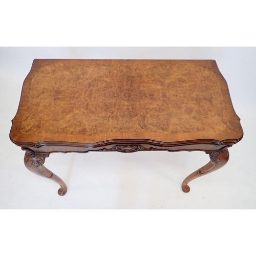 926 - A 20th century walnut fold top card table with scroll craved apron and shell and scroll carved cabri... 