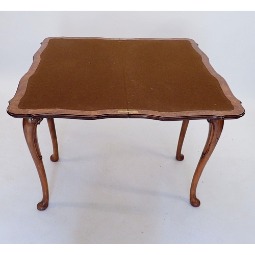 926 - A 20th century walnut fold top card table with scroll craved apron and shell and scroll carved cabri... 