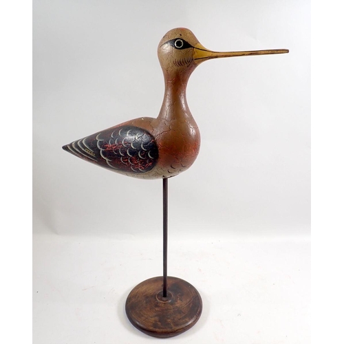 932 - An antique Folk Art carved and painted wooden snipe on stand, 41cm