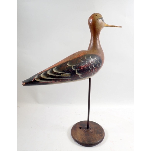 932 - An antique Folk Art carved and painted wooden snipe on stand, 41cm