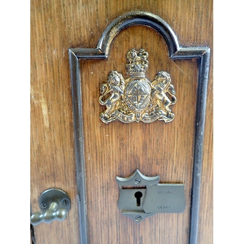 945 - A Victorian oak smokers cabinet in the form of a safe, with fitted interior and key, 30 x 23 x 32cm