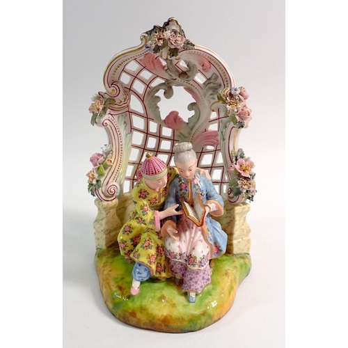 96 - A 19th century Meissen style group of Chinese couple seated reading in floral and scrollwork bower, ... 