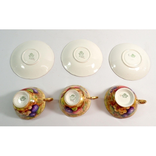 99 - Three Aynsley Orchard Gold cups and saucers painted fruit with two cups and one saucer signed A Jone... 