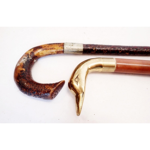 992 - A military Royal Artillery walking stick and a ducks head walking stick with interior flask