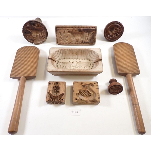 1104 - A collection of carved antique butter moulds including cows, bull and swan and a pair of butter pats