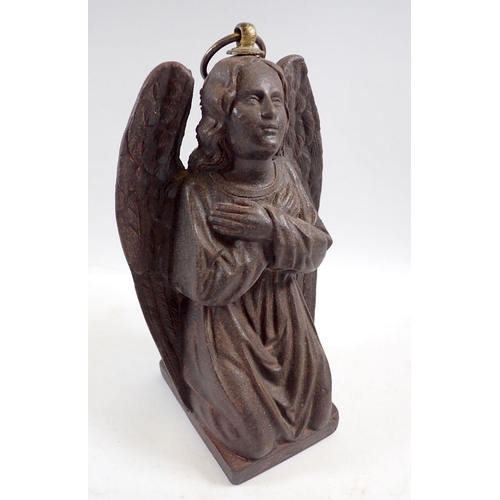 1109 - A cast iron kneeling angel with ring fitting to top, 22cm